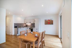 a kitchen and dining room with a wooden table and chairs at Kiefer in Ravensburg +14 photos