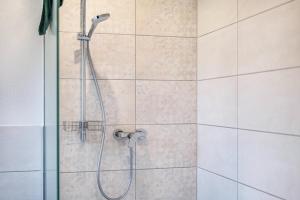 a bathroom with a shower with a shower head at Kiefer in Ravensburg
