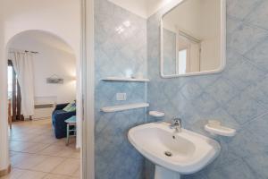 a bathroom with a sink and a mirror at Casa Vacanze Pistacchio in Murta Maria +14 photos