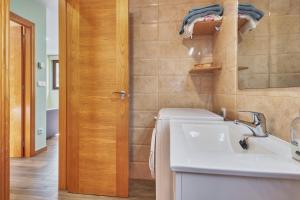 a bathroom with a sink and a mirror at Valle del Ibias - Primero Derecha in Cecos +15 photos