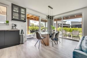 a kitchen and living room with a table and chairs at Casa Bos Schotsman Wellness in Kamperland