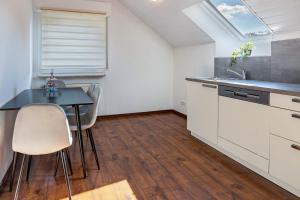 a kitchen with a table and chairs and a window at Ülger in Pfullendorf +10 photos