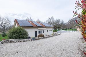 a house with solar panels on the roof at La maison dans les noyer in Sainte-Eulalie
