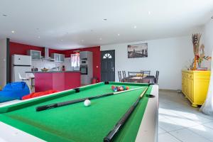 a living room with a pool table with balls on it at La maison dans les noyer in Sainte-Eulalie