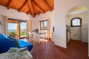 a living room with a blue couch and a table at Villa Giada in Stintino