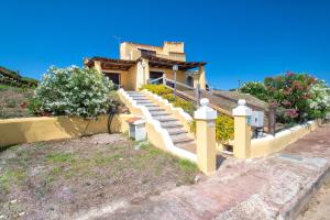 a house with stairs in front of a house at Villa Giada in Stintino