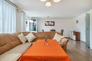 a living room with a couch and a table at Storchennest in Markdorf