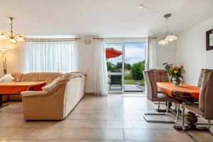 a living room with a table and a dining room at Storchennest in Markdorf