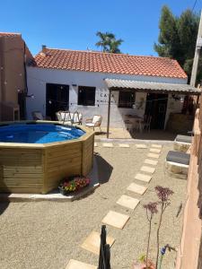 a backyard with a swimming pool and a house at Casa Amigos Rural in Cuevas del Almanzora
