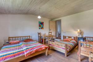 a bedroom with two beds and a table and chairs at Maison Abricot avec piscine in Aspiran +19 photos