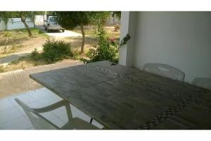a wooden table and chairs on a patio with a view at Maria's house 2 in Ilia