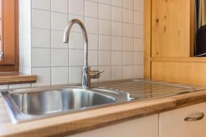 a stainless steel sink in a kitchen at Kristiania Apartement Typ A2 in Siusi +13 photos