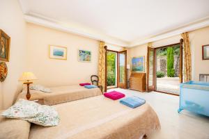 two beds in a room with two windows at Ca Nostra de Esporlas in Esporlas +31 photos