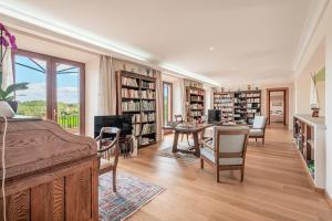 a living room with a bed and bookshelves at Ca Nostra de Esporlas in Esporlas