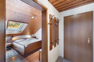 a small bedroom with a bed and a window at Haus Huber in Wolfach
