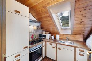 a small kitchen with a sink and a stove at Haus Huber in Wolfach