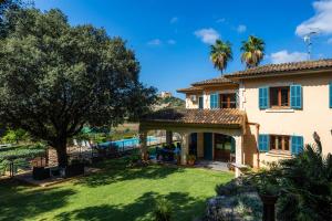 a house with a large yard with a pool at Es Pujols in Artá