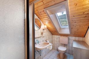 a small bathroom with a sink and a toilet at Haus Huber in Wolfach +16 photos