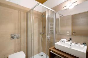 a bathroom with a shower and a sink and a toilet at Kriendl Nr 2 in Valdaora +20 photos