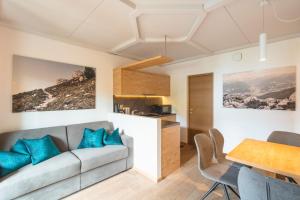 a living room with a couch and a table at Kriendl Nr 2 in Valdaora