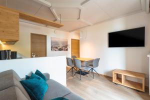 a living room with a couch and a table at Kriendl Nr 2 in Valdaora