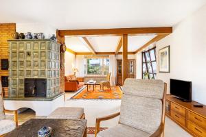 a living room with a fireplace and a tv at Ferienhaus Hebborn in Bergisch Gladbach