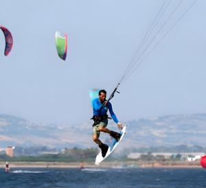 a man on a surfboard in the water at Casa La Piazzetta in Marsala