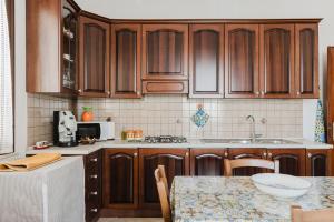 a kitchen with wooden cabinets and a counter top at Casa La Piazzetta in Marsala