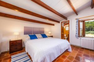 a bedroom with a large white bed and a window at La Fortaleza in Pollença +30 photos