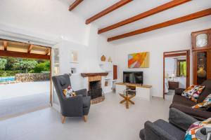 a living room with a couch and a fireplace at La Fortaleza in Pollença