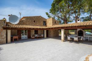 a large patio in front of a stone house at La Fortaleza in Pollença