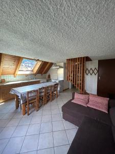 a kitchen with a table and chairs in a room at Chalet Moulinot in Valloire