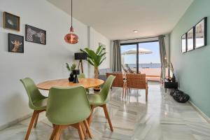 a dining room with a table and chairs at 2-bedroom apartment with seaview in Nerja