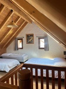 a bedroom with two beds in a attic at Chalet Moulinot in Valloire +31 photos