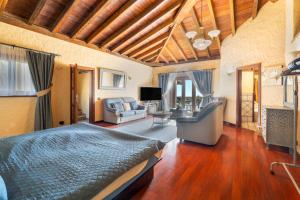 a bedroom with a bed and a living room at Finca Toledo in San Miguel de Abona