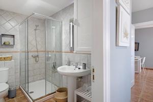 a bathroom with a glass shower and a sink at Apartamento La Estrella II in Playa Blanca +13 photos