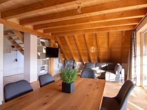 a living room with a wooden table and chairs at Haus Mühlenfranzenhof in Schönwald