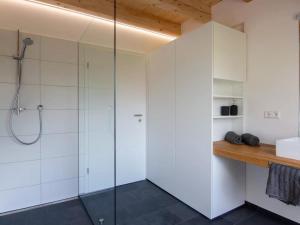 a bathroom with a glass shower stall and a sink at Haus Mühlenfranzenhof in Schönwald +8 photos