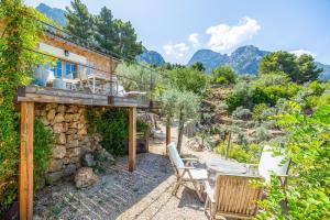 an external view of a house with mountains in the background at Els Abats in Fornalutx