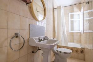 a bathroom with a sink and a toilet and a mirror at Apartamento las Palmeras 4 in Benicarló +17 photos