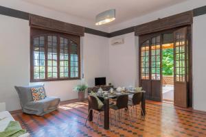 a living room with a table and a chair at Villa I Tigli - Pervinca in Campiglia Marittima