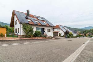 a house with solar panels on the roof at Haus Gartenblick in Annweiler am Trifels