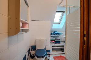 a bathroom with a toilet in a small room at Courseulles Comme À La Maison in Courseulles-sur-Mer +16 photos