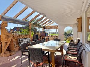 an outdoor patio with a table and chairs at Haus Blaulichtfamilie in Opfenbach