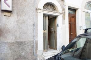 a car parked in front of a building with a door at Dimora D'Incanto in Ragusa