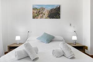 a bedroom with a bed with two lamps on it at Casa Cherie con piscina privada in Ronda