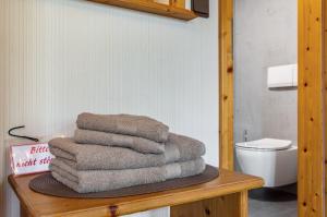 a pile of towels sitting on a table in a bathroom at Wein- und Gästehaus Lutz in Iphofen +52 photos