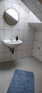 a bathroom with a sink and a mirror and a blue rug at Peter in Michelstadt