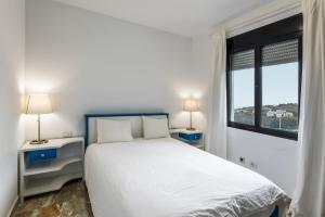 a white bedroom with a bed and a window at Lujan 6f Entre Sueños Y Realidad in Puntallana