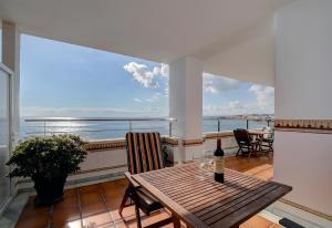 a table with a bottle of wine on a balcony at Apartment Boulevard 302 in Estepona